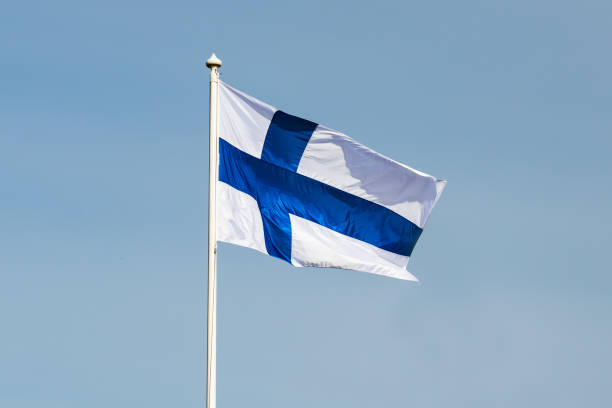 istock Finnish national flag on the wind against the blue sky 1256995680