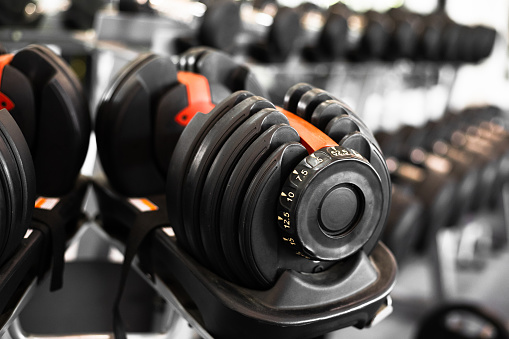Close up dumbbells set for a exercise in the fitness gym.