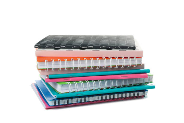 istock Pile of different notebooks isolated on white background 1256999098