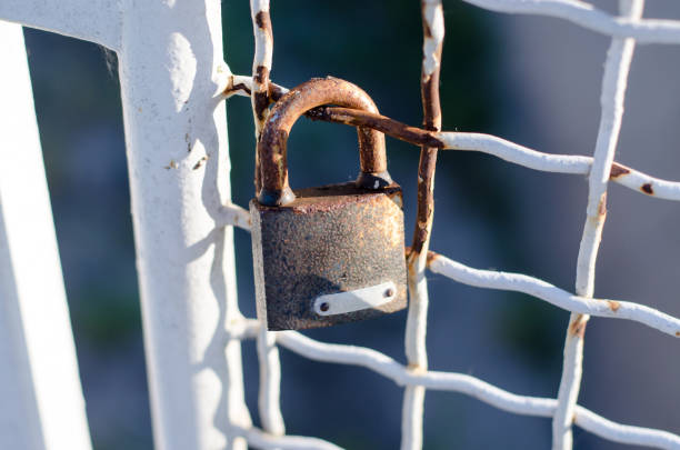 istock Old lock hanging on the railing of the bridge. 1257000295