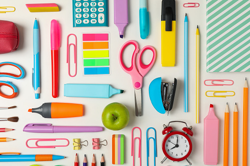 Flat lay with different school supplies on white background