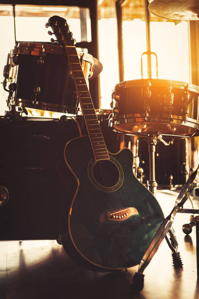 istock Guitar sitting on the ground and sun light at music studio. 1257001056