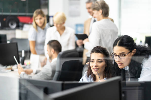 istock Two female businesswomen looking at PC discussing financial projects 1257003174
