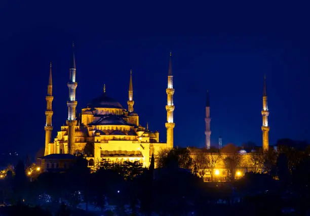 The Blue Mosque at golden night lights, dusk in Istanbul. Sultanahmet Camii mosque with six minarets is famous islamic monument of the Ottoman architecture in Turkey.