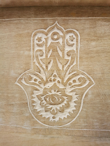 Hamsa symbol on wood