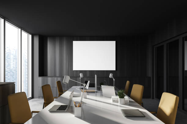 istock Minimalist dark wood open space office with poster 1257007585