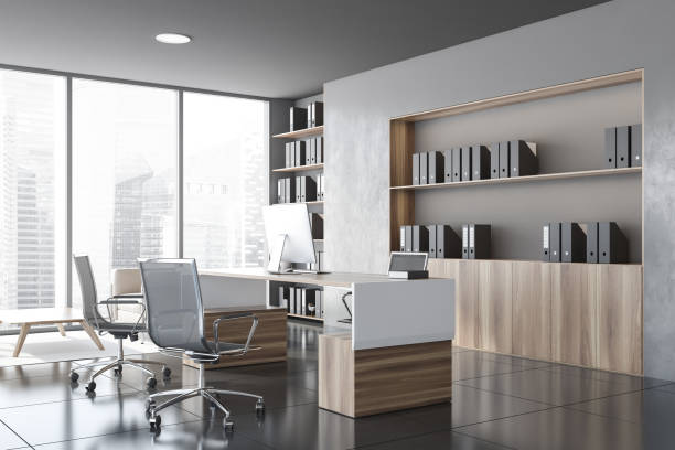 istock Gray and wooden CEO office corner with bookcase 1257008337