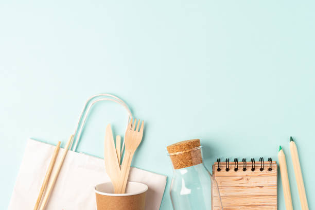 istock Craft bag, glass jar and recycled tableware top view. Flat lay Zero waste, eco friendly, natural organic plastic free concept. Cutlery, earth, biodegradable on mint background with copy space 1257008338
