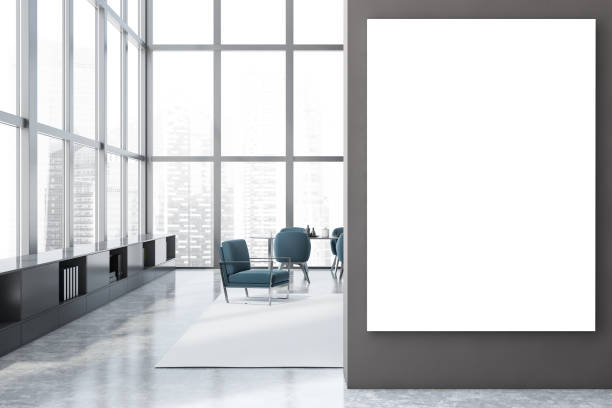 istock Gray dining room with blue armchairs and poster 1257008384