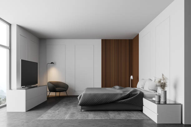 istock White and wooden bedroom with TV, side view 1257008621