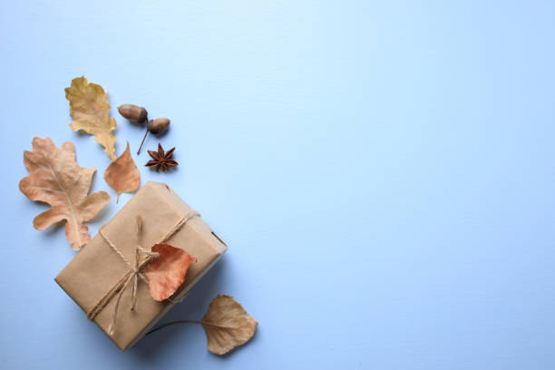 istock Handmade paper gift box with dried leaves decor 1257008972