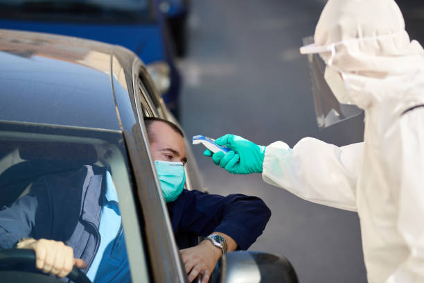 istock Measuring temperature at drive through checkpoint due to coronavirus pandemic! 1257009871