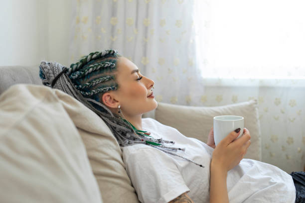 Woman relaxing with coffee on a sofa