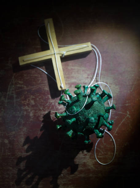 istock Coronavirus 2019-nCov novel coronavirus concept. Crowd looking on big Corona virus model at night with fog and backlight. Creative artwork decoration. Selective focus. 1257010088