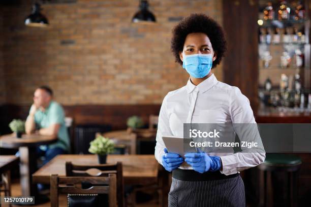 Portrait Of African American Waitress With Protective Mask In A Cafe Stock Photo - Download Image Now