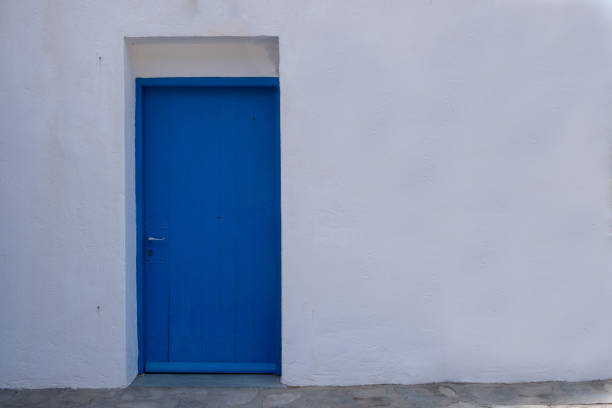 istock Blue color door on a white wall, greek island architecture, copy space 1257010232
