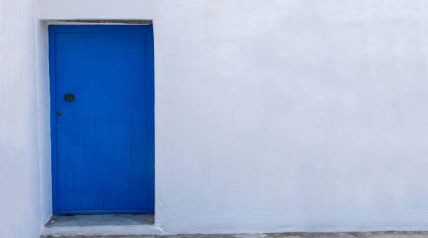 istock Blue color door on a white wall, greek island architecture, copy space 1257010233