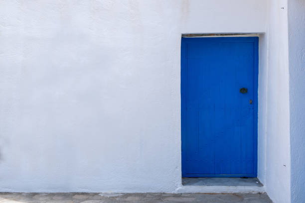 istock Blue color door on a white wall, greek island architecture, copy space 1257010237