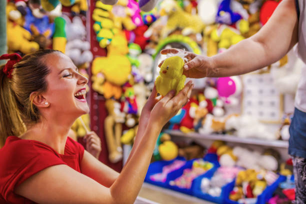 istock Girl in amusement park with toy 1257010312