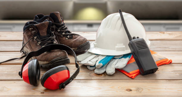 istock Work safety protection equipment. Industrial protective gear on wooden table, blur construction site background. 1257010362