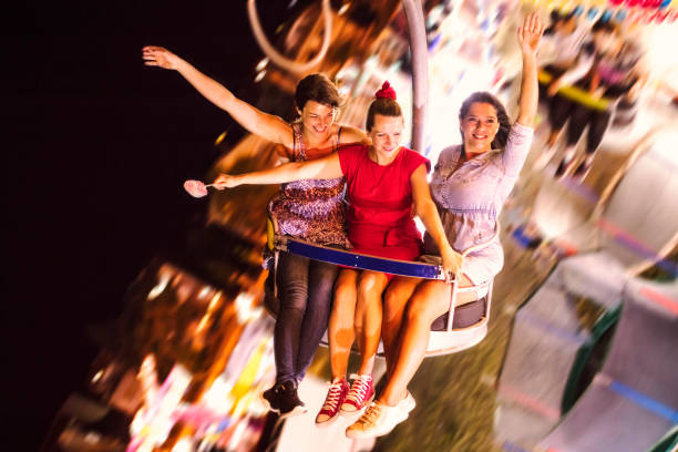 istock Girls on swing ride at night 1257012025
