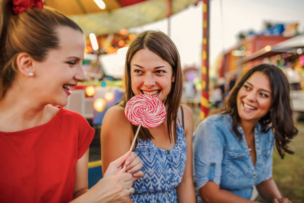 istock Girls fooling around with lollipops 1257012191