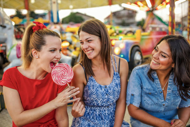 istock Girls fooling around with lollipops 1257012231
