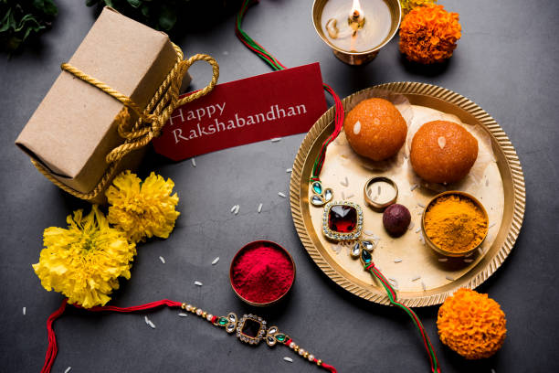 Indian festival Raksha Bandhan with rakhi bracelets, presents, rice and kumkum in bowls. Copy space stock photo