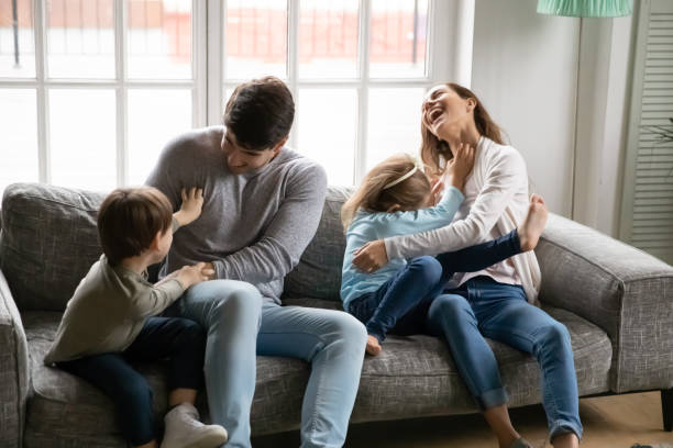 istock Overjoyed family with kids have fun playing at home 1257016162