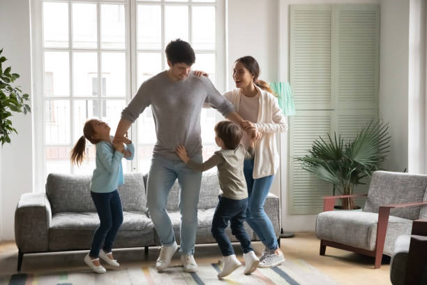 istock Overjoyed family with small kids dancing together 1257016193