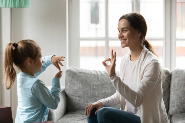 istock Young mom practice sign language with little daughter 1257016194