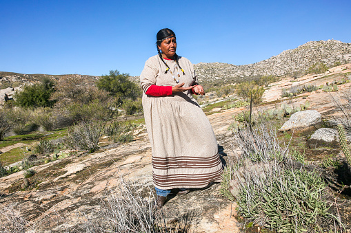 Baja California, Mexico, January 04 -- A representative of the Kumeyaay Indian community with traditional clothes visit a sacred area in the Indian reserve near the border between Mexico and the United States in the Tecate region in the state of Baja California, northern Mexico. The Kumeyaay, also known as Tipai-Ipai or Kumiai, are a tribe of indigenous peoples of the Americas who live between northern Mexico and southern California, along a binational territory straddling the border which is considered essential for their survival. The Kumeyaay people are known as the oak people, a tree considered sacred and a source of sustenance, warmth and protection.