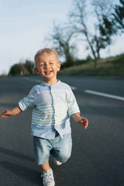 istock Little boy walking on the road 1257018677