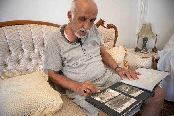 istock Senior man looking at his old pictures 1257018864