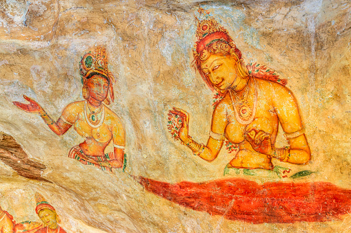 Ancient cave paintings of Sinhalese maidens performing various tasks, Sigiriya, Sri Lanka. The paintings are believed to be over 1,500 years old (the frescoes are classified as in the Anuradhapura period) and the true significance is unknown. Also names of artists are unknown.