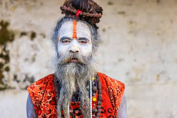 This Sadhu uses ashes of cremated remains to prepare specific white color of his makeup.
In Hinduism, sadhu, or shadhu is a common term for a mystic, an ascetic, practitioner of yoga (yogi) and/or wandering monks. The sadhu is solely dedicated to achieving the fourth and final Hindu goal of life, moksha (liberation), through meditation and contemplation of Brahman. Sadhus often wear ochre-colored clothing, symbolizing renunciation.