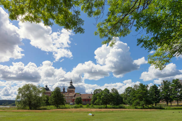 Summer in Mariefred A person relaxes on a large park lawn in Mariefred, in front of the historical Gripsholm Castle. mariefred stock pictures, royalty-free photos & images