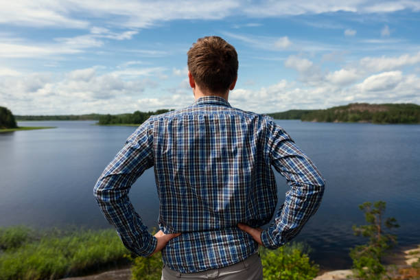 istock Rear view of man looking lake resting during trekking. 1257021106