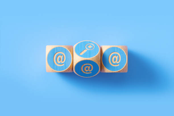 istock At Symbol Written Blue Wood Blocks Sitting over Blue Background 1257022320