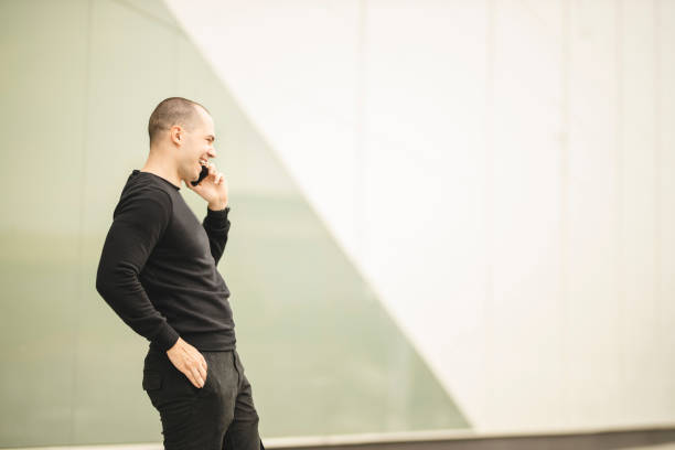 istock Happy young man speaking on the phone and smiling 1257022772