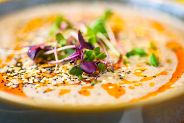A serving of mushroom soup in a round blue textured bowl