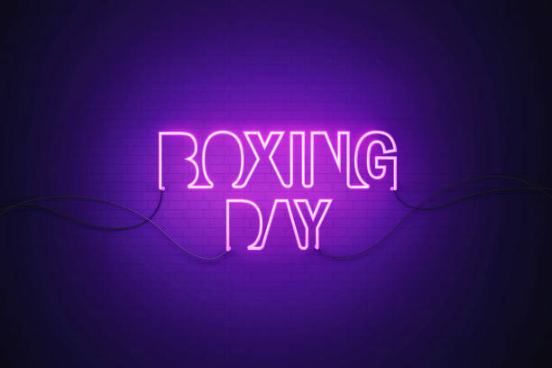 Purple neon light writes Boxing Day on black wall. Horizontal composition with copy space. Boxing Day concept.