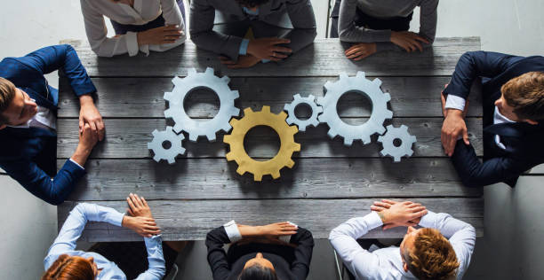 istock Business people joining gears 1257025881