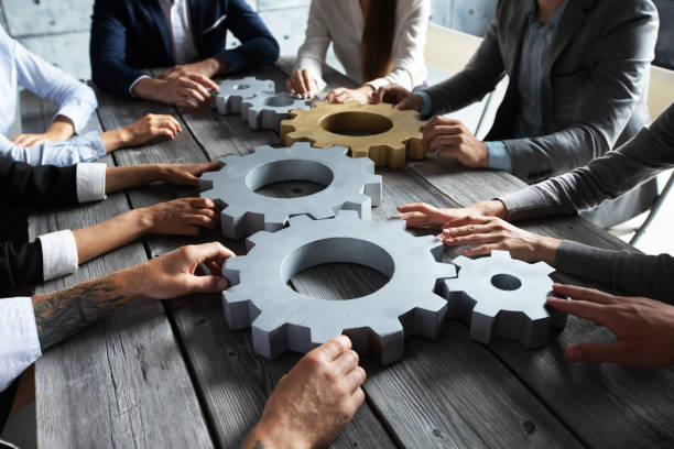 istock Business people joining gears 1257025883