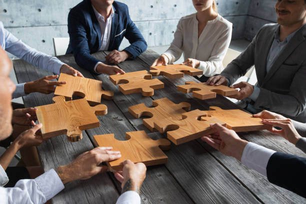 istock Business people and puzzle pieces 1257026462