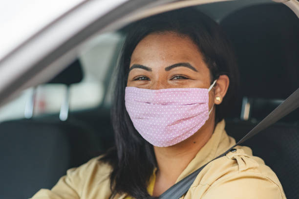istock Covid-19: Smiling woman driving car 1257026598