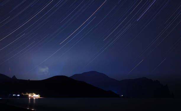 Long exposure starry landscape of Lisya Bay Long exposure starry landscape of Lisya Bay, near settlement Kurortnoye, urban district of Feodosia, Republic of Crimea, Russia, former Ukraine, Karadag mountain lisya bay stock pictures, royalty-free photos & images