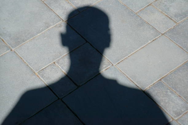istock Shadow of a man on the pavement. 1257027835