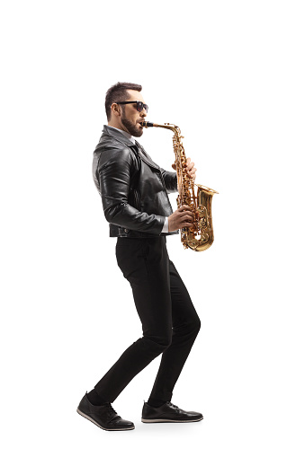 Full length profile shot of man playing a saxophone musical instrument isolated on white background