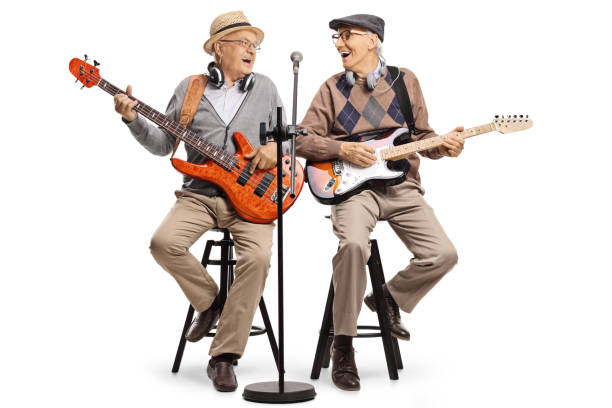 istock Cheerful elderly men sitting on chairs playing guitars and singing 1257028245